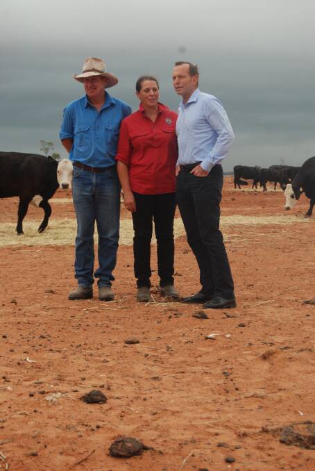 RESCUE PACKAGE: Bourke farmers Phillip and Di Ridge show Prime Minister Tony Abbott around their property. 
Photo: GRACE RYAN