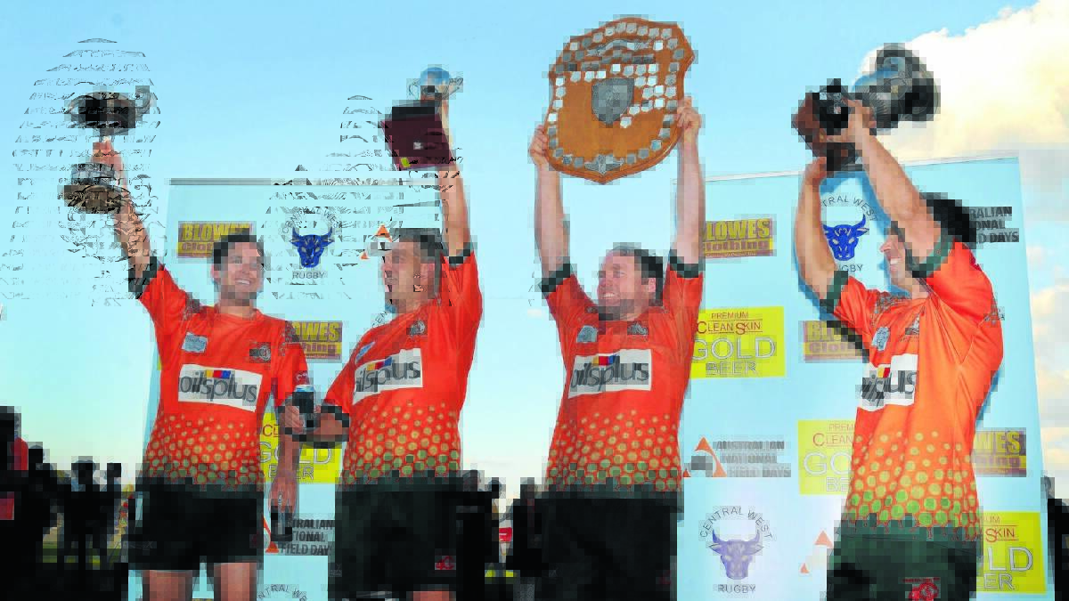 TROPHY HAUL: Orange City players Sam Coote, Chris Barrett, Josh Tremain and Michael Sparks with last season’s club championship, minor premiership, Blowes Clothing Cup shield and  Blowes Clothing Cup. The club has again dominated in 2014 in both junior and senior competitions.