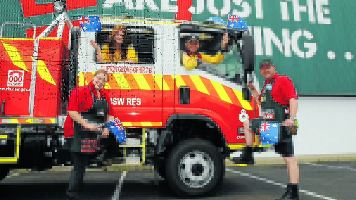 AUSSIE PRIDE: Clifton Grove Ophir Rural Fire Brigade publicity officer Alyce Selwood and captain Ray Astill (back) and Bunnings Warehouse Orange staff Penny Watts and Corey Palmer look forward to the Aussie Day Weekend Fundraiser Barbeque on Saturday. Photo: STEVE GOSCH                                      0120sgrfs3
