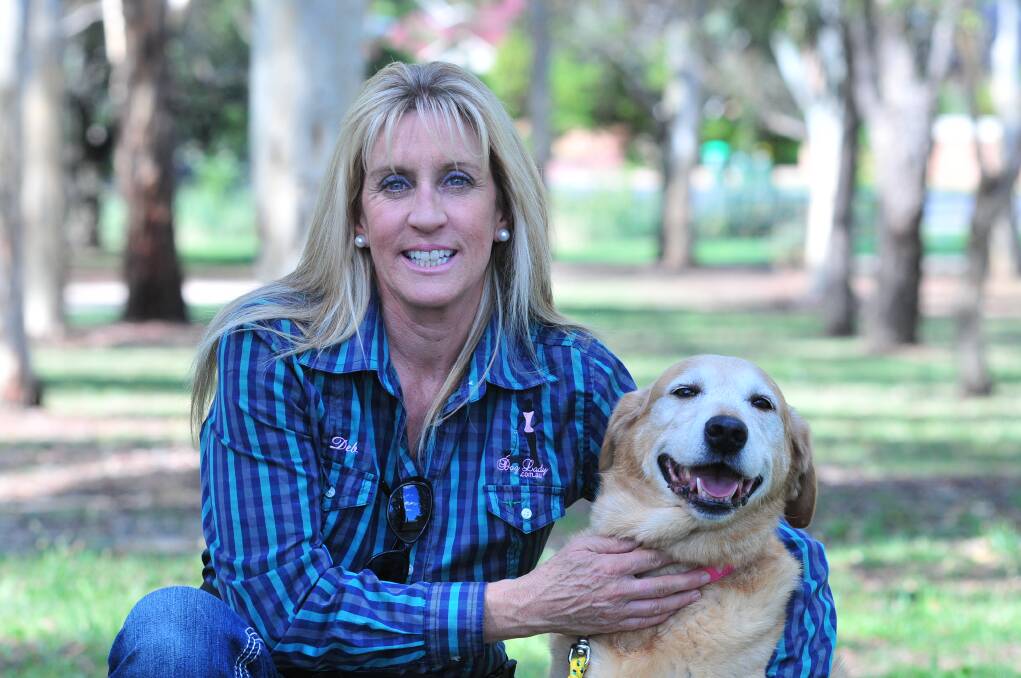PLAN AHEAD: Dog trainer and behaviourist Deb Coleman, with her dog Honey, says people need to have the right training and equipment before they walk their dogs in public. Photo: JUDE KEOGH  0224dogs3

