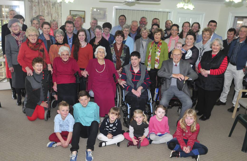 WHAT A MILESTONE: Surrounded by her family and friends, Doris Webster (second row third from left) celebrated her 100th birthday at the Parkwood Hostel on Saturday. Photo: JUDE KEOGH                                                                                                                    0524webster15