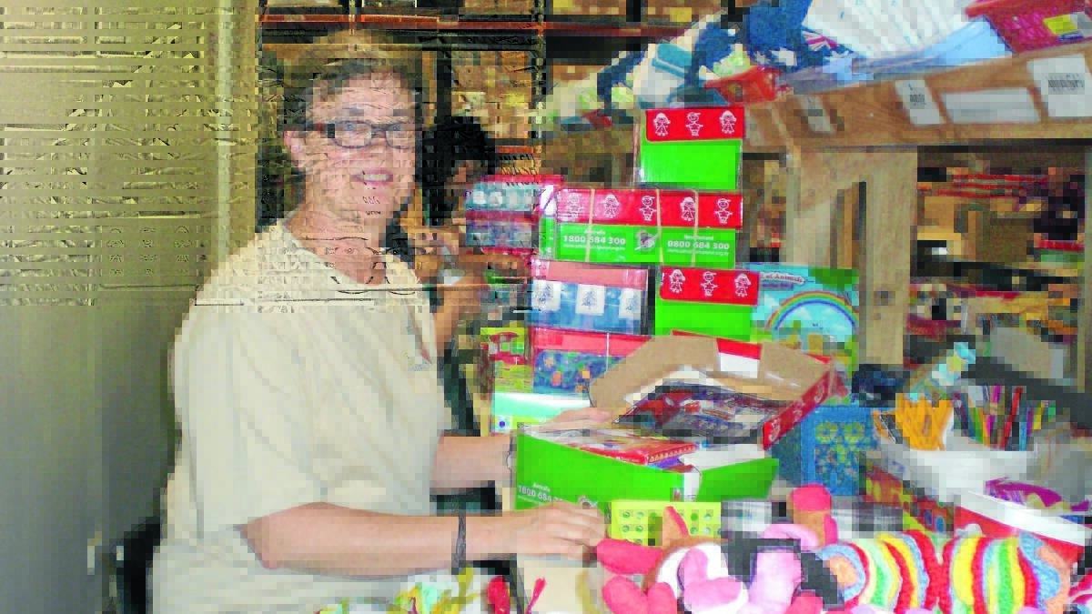 GIFT GIVING: Robyn Hicks checks some of the thousands of shoeboxes heading to Vietnam for Operation Christmas Child.
Photo: SUPPLIED 1205tmopxmaschild2.