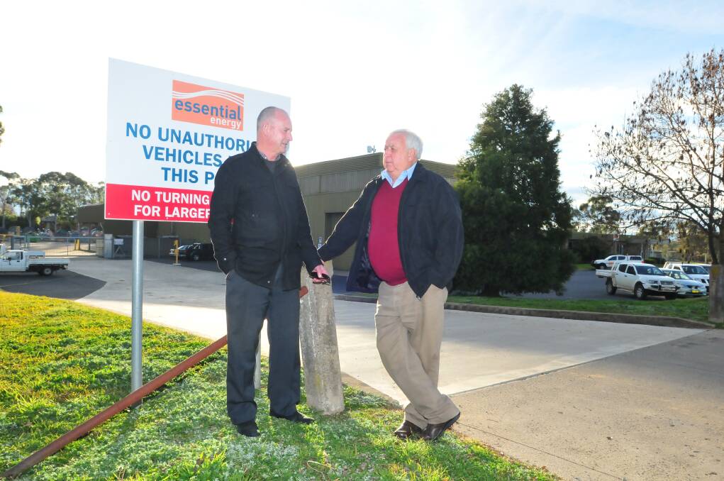 SAFE FOR NOW: Central West Union Alliance representative Bernard Fitzsimon and Orange councillor Ron Gander outside the Essential Energy depot in Orange which has survived the sell off of the state’s electricity assets. 
 Photo: JUDE KEOGH   0610powersell1