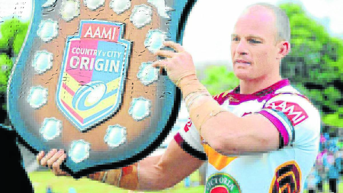 UP FOR GRABS: Country captain Beau Scott with the Country v City Origin shield after the fixture at Dubbo this year. The match is a chance of retuning to Caltex Park in 2015. Photo: LOUISE DONGES