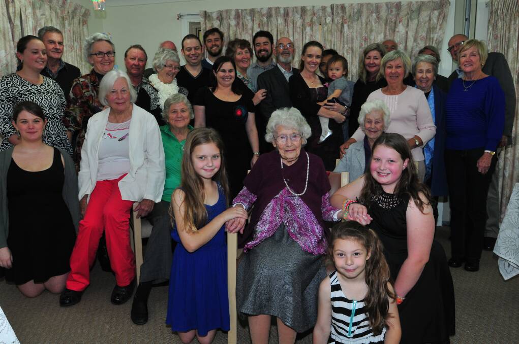 HAPPY RETURNS: Irene Whibley with great-grandchildren Chiara, Lily and Analise Whibley and (behind) her family and friends. 
Photo: JUDE KEOGH 0426hundred8
