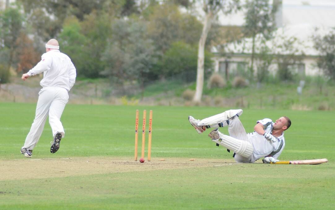 STOP, DROP AND ROLL: Wanderers batsman Scott Hanrahan hits the deck after being run out by Kinross bowler Charlie Cooper. Photo: STEVE GOSCH                                                                                                         0315sgcrick1