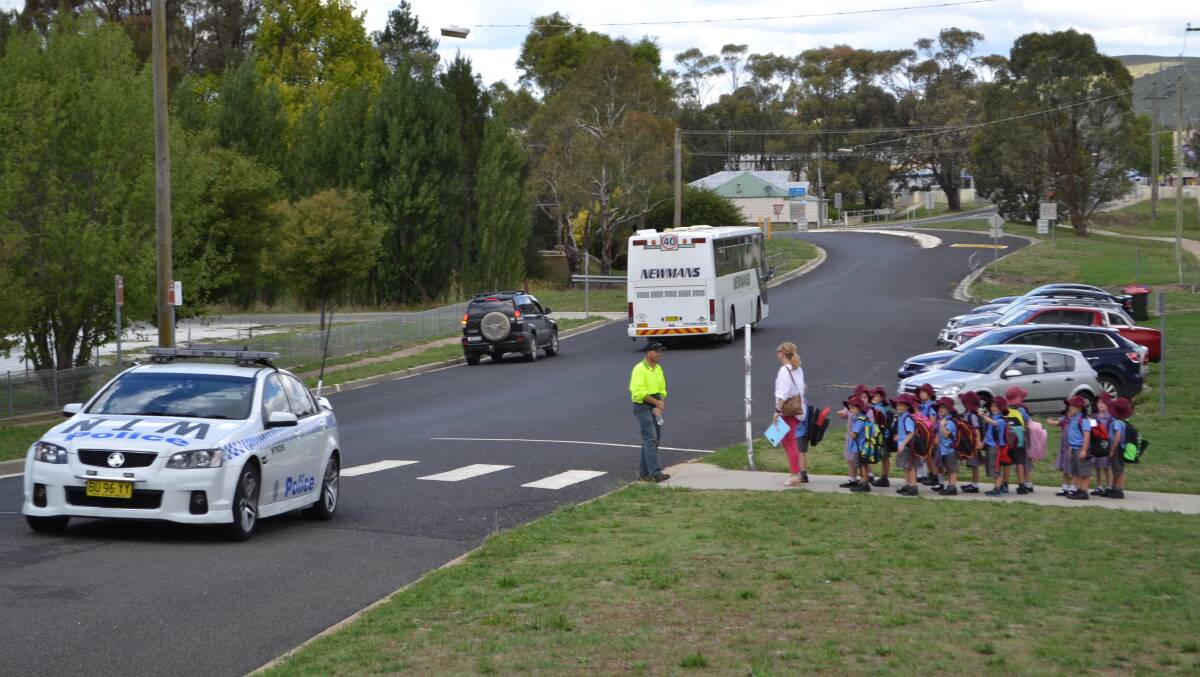 ORDERLY EVACUATION: St Joseph’s Catholic School students in Blayney leave the school after being evacuated on Thursday. Photo: BRYANT HEVESI.                                                        spill 5