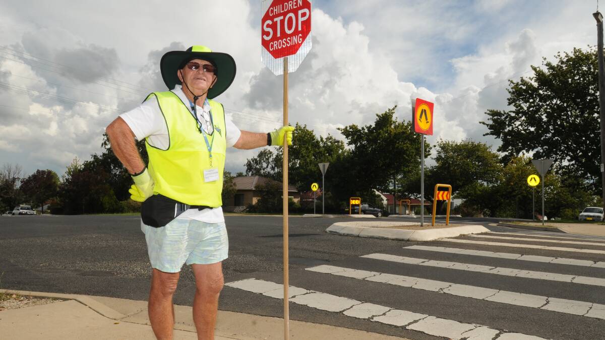 RISKY BUSINESS: Bob Bell says speeding drivers make his life as a lollipop man dangerous. Photo: STEVE GOSCH                                        0403sgcrossing1
