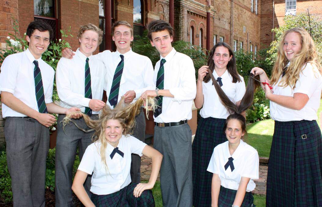 BALDING BEAUTIES: Year 11 students (back) Alasdair Denholm, Charlie Cooper, Ben Watt, Harry Lovell, Nicola Kermode, Maddie Adams, (front) Mia Hull and Emily Wright have raised about $10,000 ahead of their head shave.                                                                                                        Photo contributed
