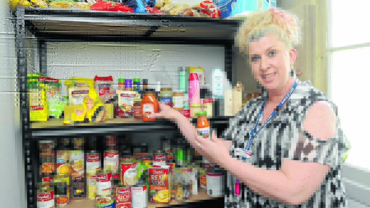 CHRISTMAS IS COMING: Anglicare’s Christie McGuirk urges the community to dig deep for the pantry appeal. Photo: STEVE GOSCH                                                                                                                    1010sganglicare2