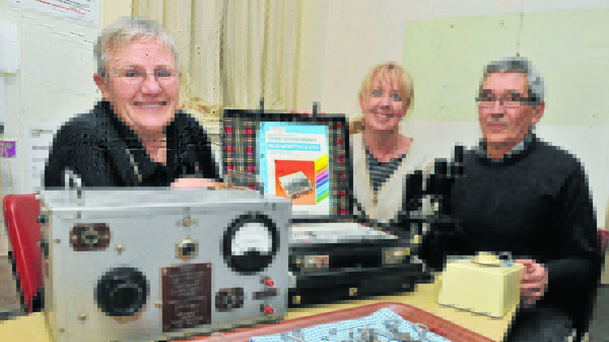 BLOOMFIELD HISTORY: Museum consultant Margot Jolly with volunteers Alison Wu and Cliff Hall and some of the historic equipment being catalogued at Bloomfield. Photo: JUDE KEOGH                                                                                                                   0810museum4
