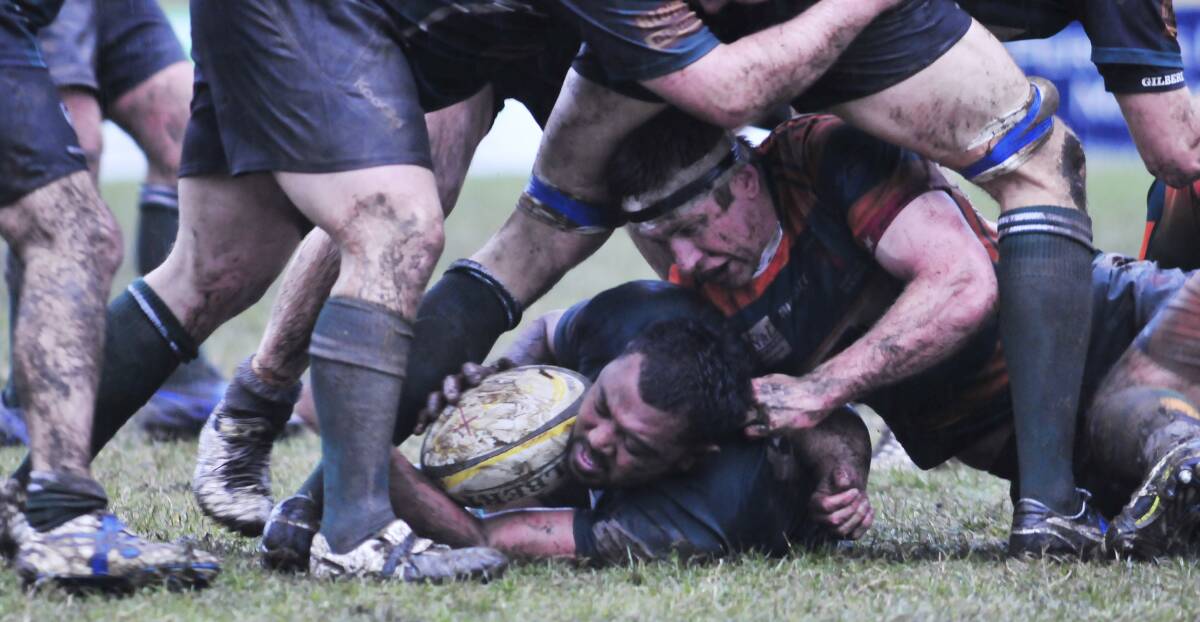 DIRTY WORK: Orange Emus' Alo Finau (left) releases the ball as Orange City's Josh Maley (right) is stuck at the bottom of the ruck. Photo: JUDE KEOGH