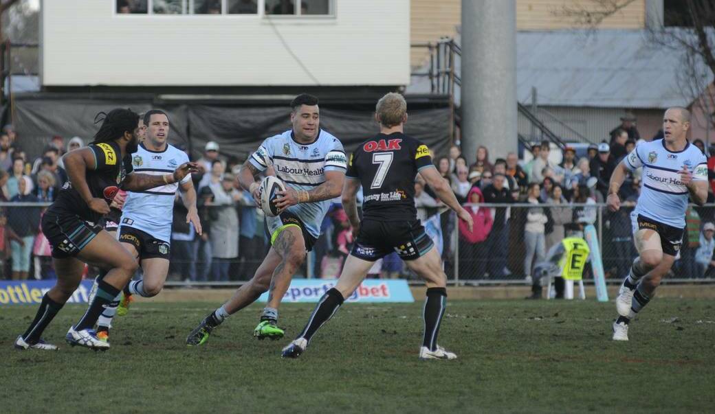 GREAT DAY, GREAT GAME: Sharks prop Andrew Fifita sizes up the Penrith defence. Photo: CHRIS SEABROOK