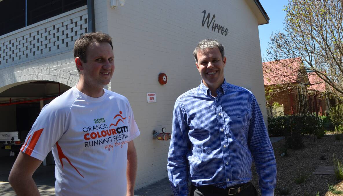 HELPING HAND: Colour City Running Festival’s David Gibson with Housing Plus’s business development manager Justin Cantelo outside the organisation’s homeless accommodation Wirri, in March Street. Photo: TRACEY PRISK 1006tprunningfest1