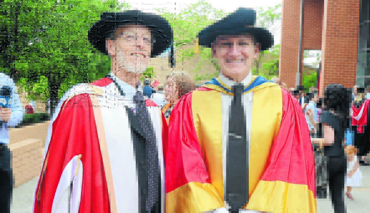 LIFETIME OF WORK: Charles Sturt University Orange professors Kevin Parton and Geoff Gurr were honoured with special awards at the university’s graduation ceremony yesterday. Photo: JUDE KEOGH
