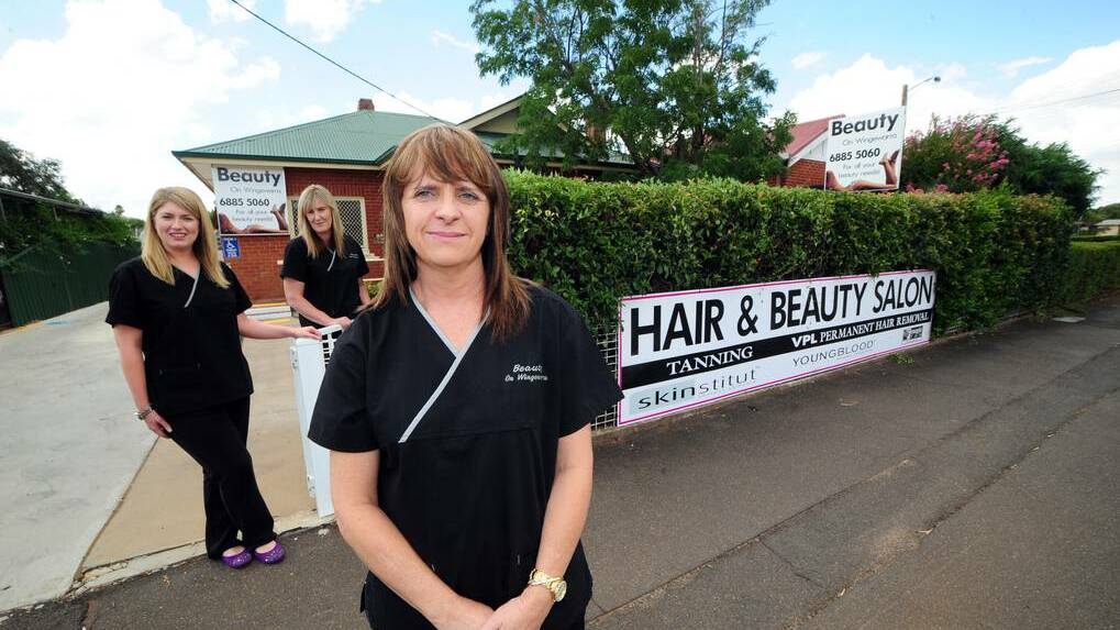 DUBBO: Beauty on Wingewarra owner Shellie Gray (front), with staff Fiona Morgan and Robyn Palmer, wants Dubbo City Council to approve a sign along the front fence of her business