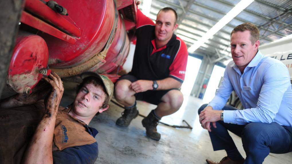 DUBBO: First year apprentice Damien Dowsett works on a truck while Hall's Transport Repairs owner Richard Hall and Skillset business manager for Dubbo and Tamworth Luke Cameron look on. Photo: Belinda Soole