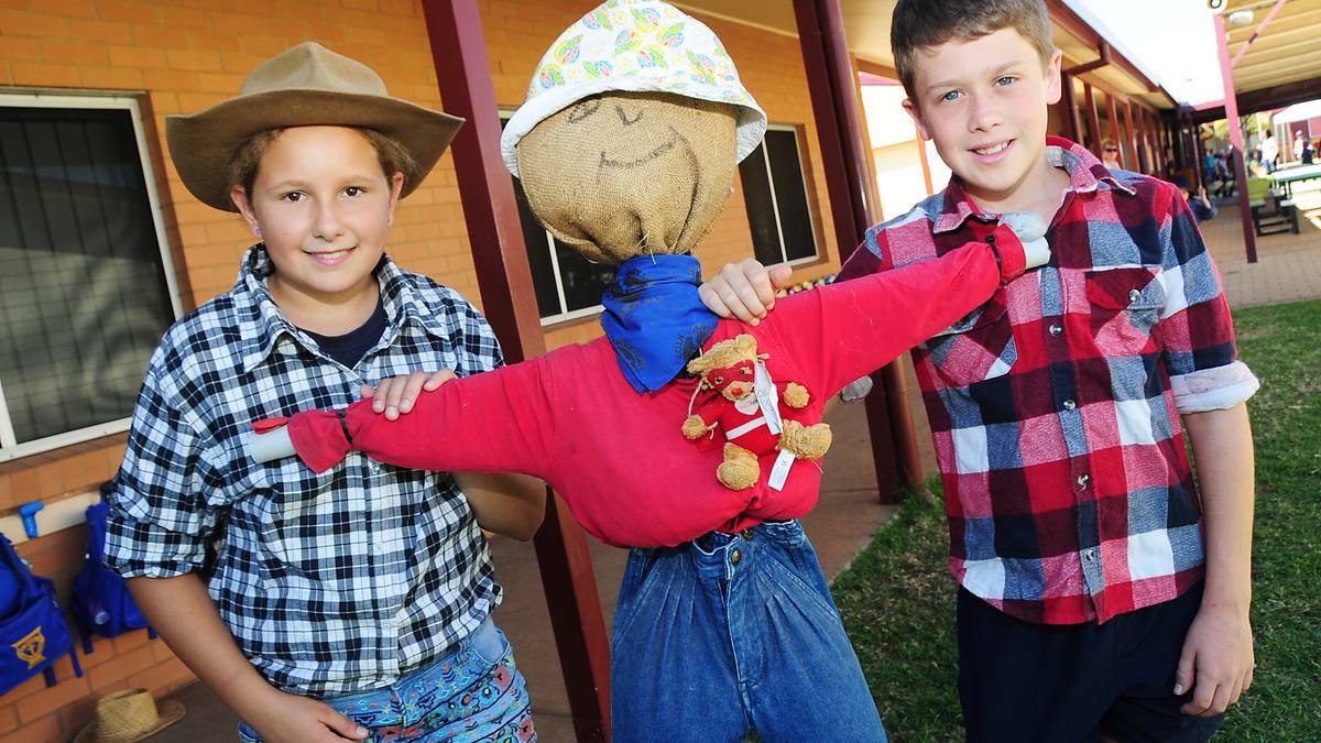 DUBBO: St Pius X school captains Madison Jones and Will Schwager with a scarecrow raising money to help drought stricken farmers.  Photo BELINDA SOOLE