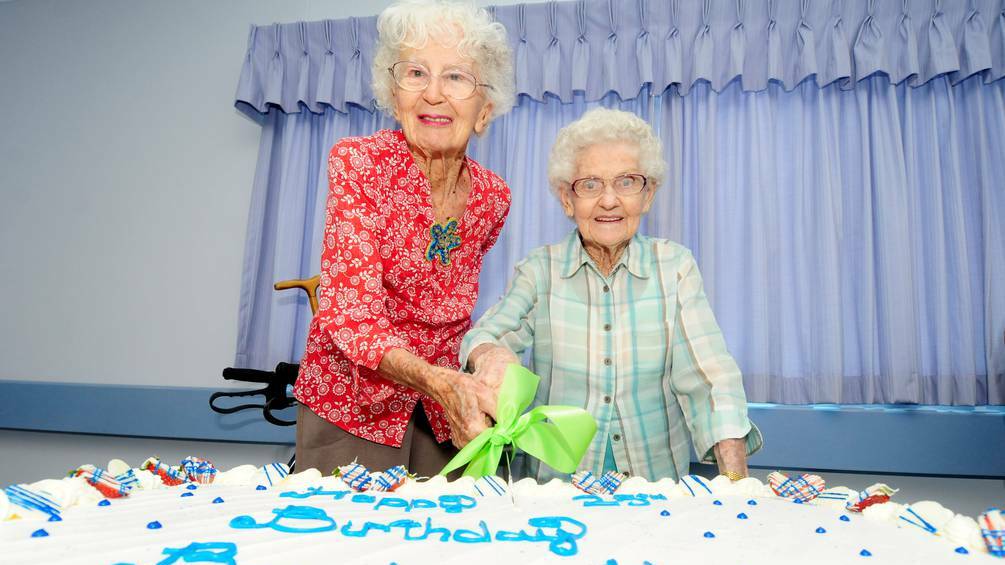 DUBBO: Residents of Bracken House Jean Martin and Mary Layard cutting the cake. Photo: LOUISE DONGES