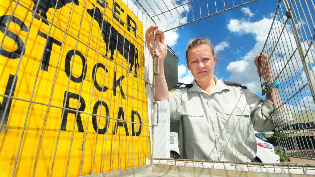 DUBBO: Dubbo City Council ranger Jodie McGowan locks the dog cage that is needed in the course of her animal control duties. The council reports increasing demand for the service as the urban and village areas grow. Photo LOUISE DONGES