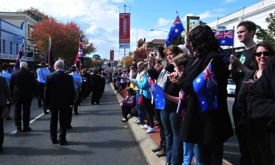 ANZAC DAY: People clap in support as the march passes by.