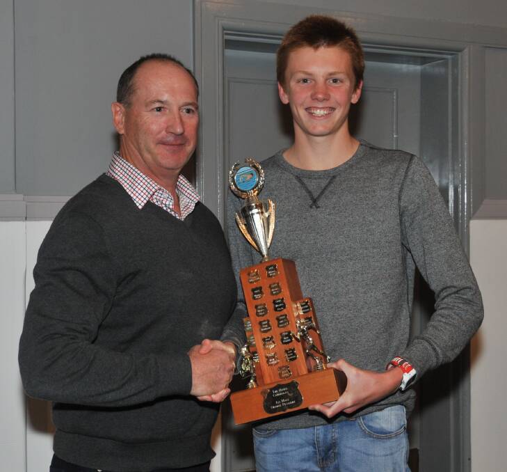 HUGE SEASON: Tony Selwood presents Connor Whiteley with OCTC's male club champion gong. Photo: JUDE KEOGH 0527jktriath5