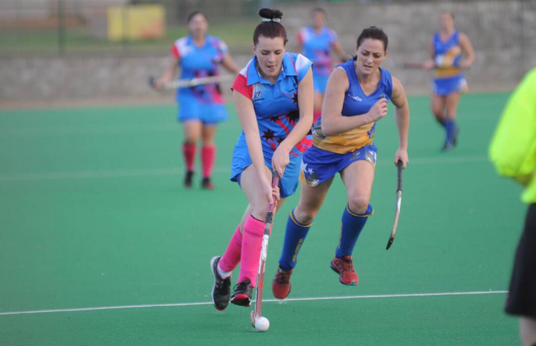 ON SONG: Dubbo Blue Jays' goal scorer Maddie Bott is pursued by Orange Ex-Services' Leanne Kennewell during their sides' draw on Saturday. Photo: CHERYL BURKE