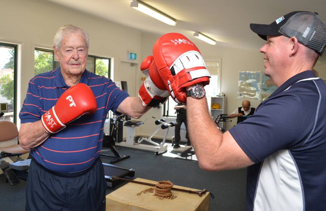 GOING STRONG: Phil Haley spars with personal trainer Jeremy Wallace. Photo: DANIELLE CETINSKI 0208dchaley3