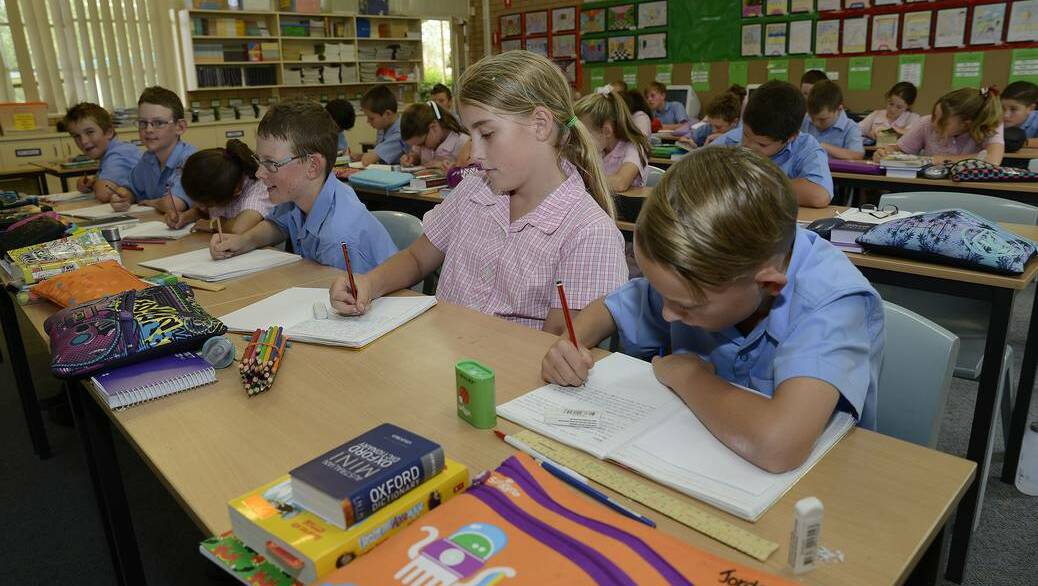 BATHURST: Sebastian Honeyman, Taylah Noonan and Jordan Ashcroft (front) and their year 5 classmates at Holy Family School work on developing their literacy skills. The school has again recorded good results.