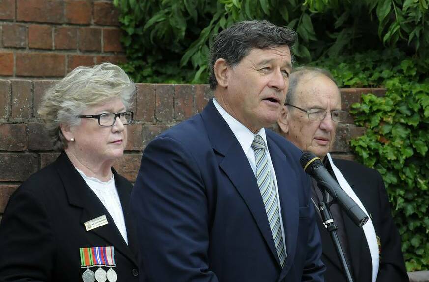 BATHURST: Member for Calare John Cobb delivers his address at the Carillon War Memorial, as Bathurst RSL Sub Branch vice president Jennifer Brennan and Reverend Howard Knowles watch on. The service marked the 72nd anniversary of the bombing of Darwin.