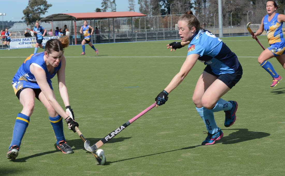 INVOLVED: Souths’ hat-trick scorer Jess Watterson (right) makes a lunge at Ex-Services’ Rachel Pengilly in Saturday’s 5-4 home win. Photo: PHILL MURRAY 	080914psouths1