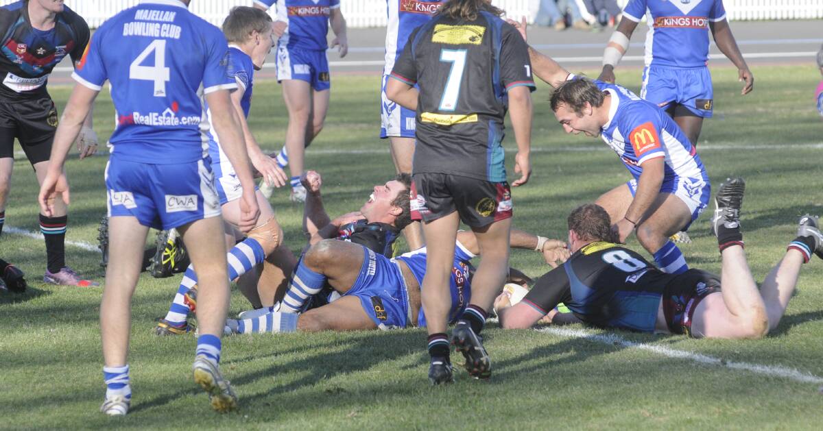 MIXED EMOTIONS: Benjamin John (centre) plants his hand on a loose ball to score the third try for St Pat's in their local derby on Sunday, while Panthers centre Jay McClintock (left) winces in pain having suffered a shoulder injury. The moment would prove pivotal as Pat's regained the lead, while Panthers lost two players, McClintock and Sandon Gibbs-O'Neill, from the same incident. Photo: CHRIS SEABROOK 	070515cpats1