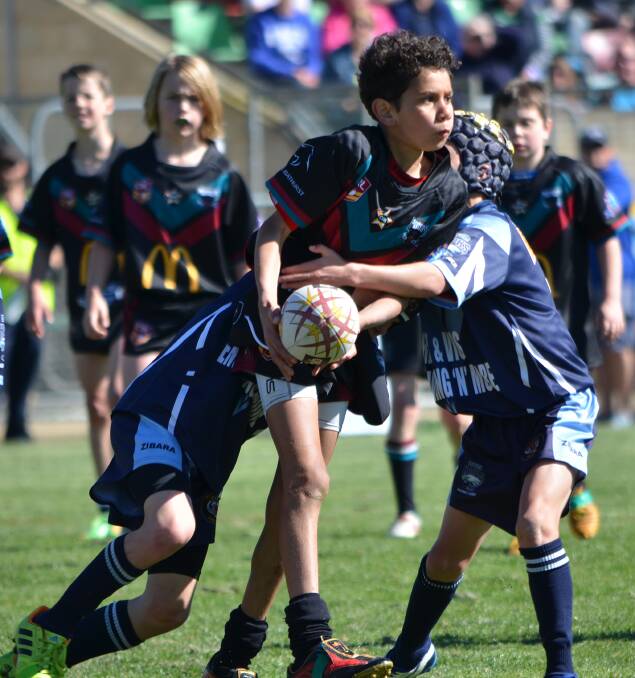LOOKING FOR SUPPORT: Panthers centre Jack Doolan tries to off-load to a team-mate during the Group 10 Junior Rugby League under 10s grand final. Photo: ANYA WHITELAW 	092014panthershot