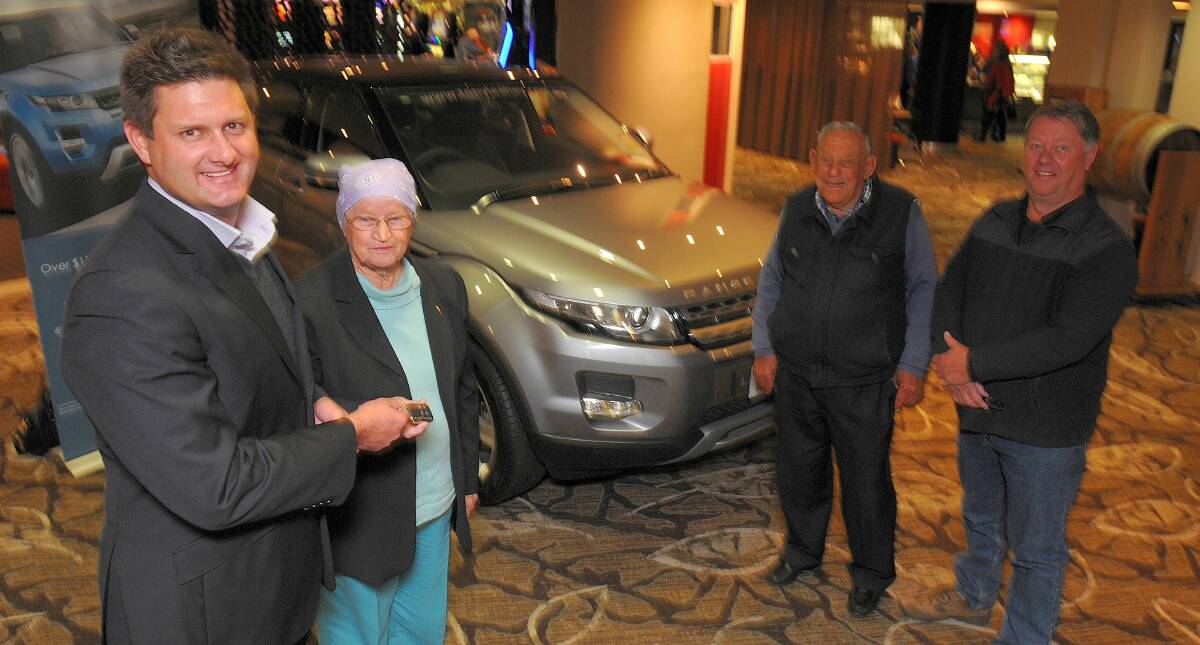 HUGE WINDFALL: Orange Ex-Services’ Guy Chapman (left) and Peter Single (far right) hand Jill Barrett and her partner Richard Lawford the keys to a brand new Range Rover Evoque. Photo: STEVE GOSCH