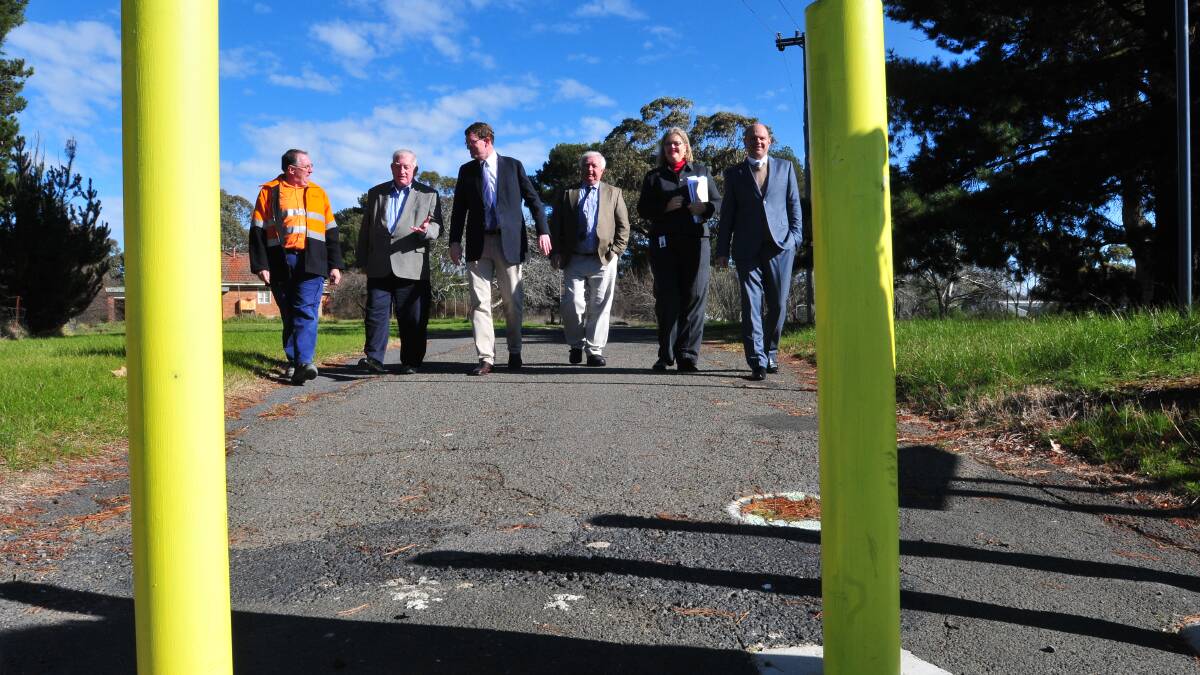 NO MORE BOLLARDS: Cadia Valley Operations approvals manager Andrew Wannan, Orange mayor John Davis, member for Orange Andrew Gee, councillor Ron Gander, Orange Health Service general manager Catherine Nowlan and Orange Ex-Services’ Club chief executive officer Cameron Provost announce $5 million in roadworks for the Bloomfield precinct. Photo: JUDE KEOGH 0709huntley8