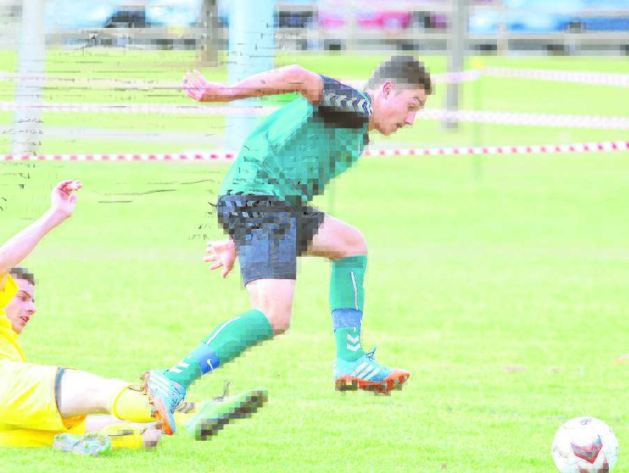 IT'S OFF THE WOODWORK: Country Western's Mickey Muratovic (green) was unlucky to hit the post in yesterday’s match against Metro East. Photo: JUDE KEOGH