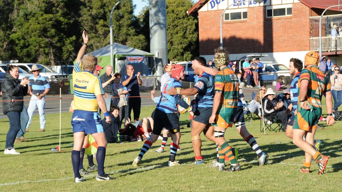Dubbo players run to celebrate with youngster Blake Sharpe (headgear) after he scored what turned out to be the match winner this afternoon. Photo: Belinda Soole