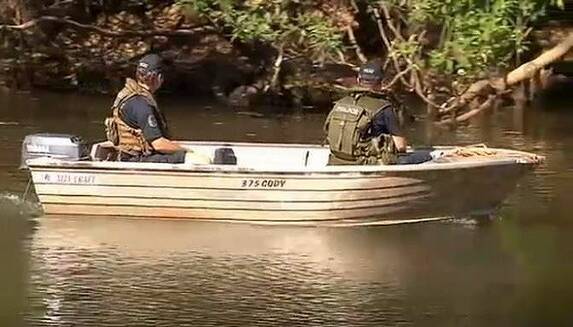 CROC SEARCH:Police search a billabong in Kakadu National Park after a man was taken by a crocodile. Photo: Channel Nine