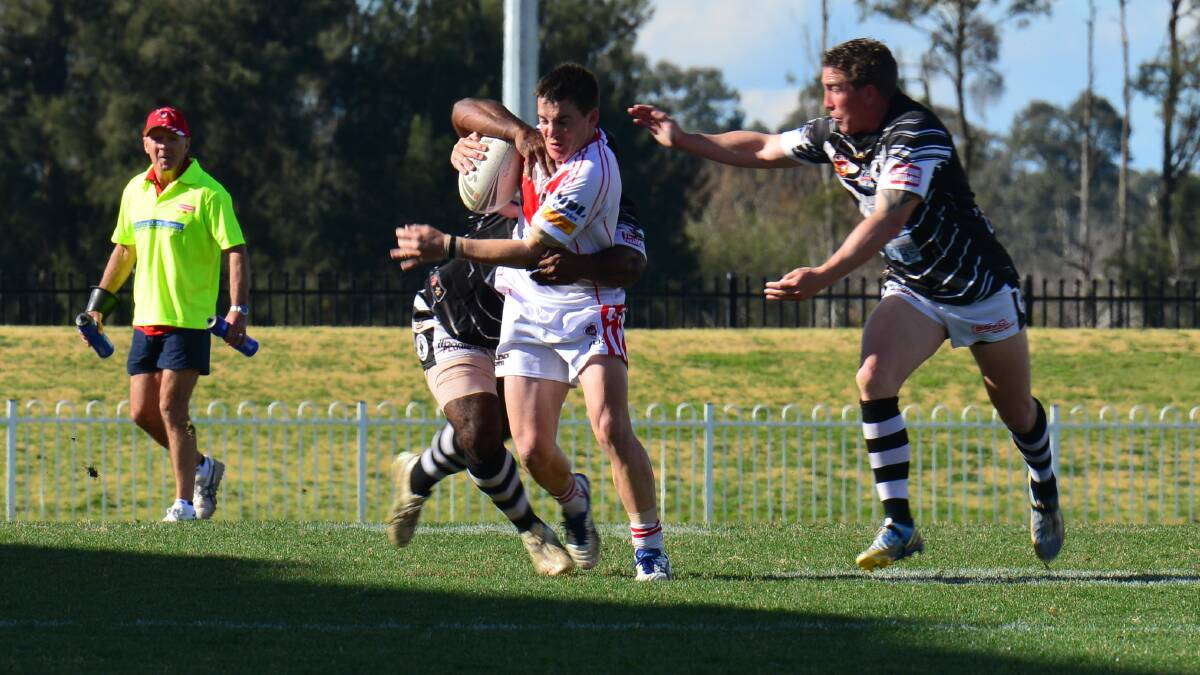 ALL OR NOTHING: Mudgee Dragons’ Ben Thompson tries to get away from Cowra defenders in last week’s semi-final loss. If the Dragons lose again, their Group 10 season is over. Photo: COL BOYD 	240814mgcbsemis1514
