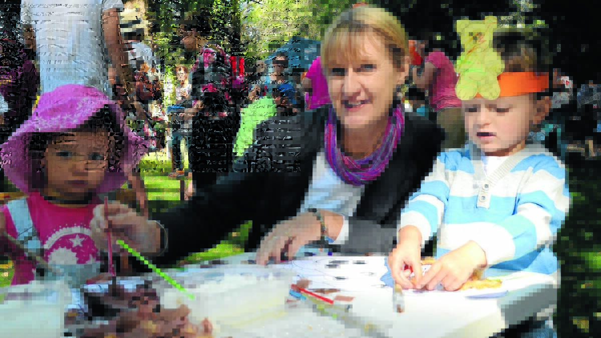 TEDDY PICNIC: Sage Houghton, Courallie Park Child Development Centre co-ordinator Karen McMullen and Levi Grelli make teddy bear masks at Saturday’s Teddy Bears’ Day Out. Photo: ALEXANDRA KING                                                                                                                                                                                                                             0314akteddy
