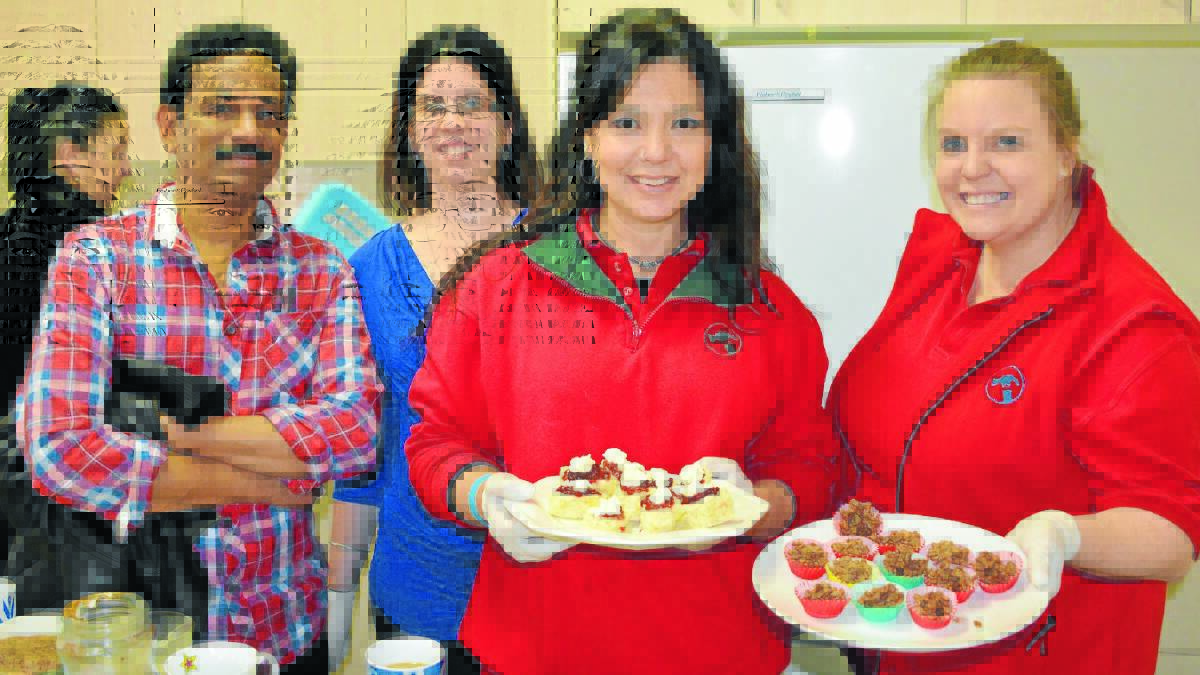 CELEBRATE GOOD TIMES: TK Shaji, Brittany Griffiths and Bunnings staff members Gina Rumney and Penny Watts were on hand to serve Meals on Wheels vounteers at yesterday's celebratory morning tea. Photo: ALLAN REEDER