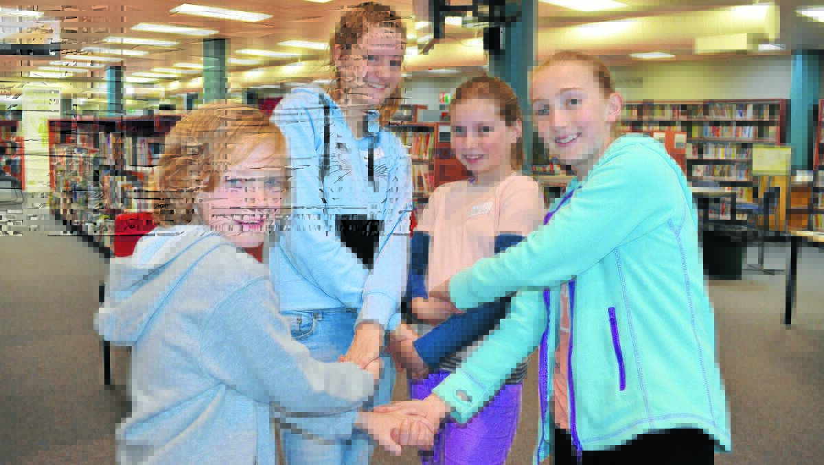 SCHOOL HOLIDAY FUN: Liam Kennedy, Miette Van Bockom Maas, Matilda Anderson and Emily L’Estrange try to untangle themselves from the human knot at Theatresports. Photo: ALEXANDRA KING 