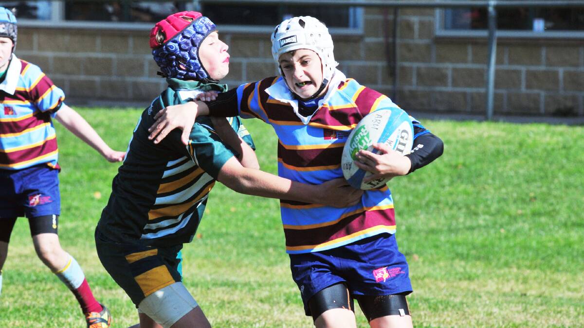 CAN’T CATCH ME:  St Augustine’s Connor Mitchell in a desparate lunge at Catherine McAuley’s Sam Littlefield during yesterday’s Western Region Primary Schools’ rugby sevens. Photo: JUDE KEOGH