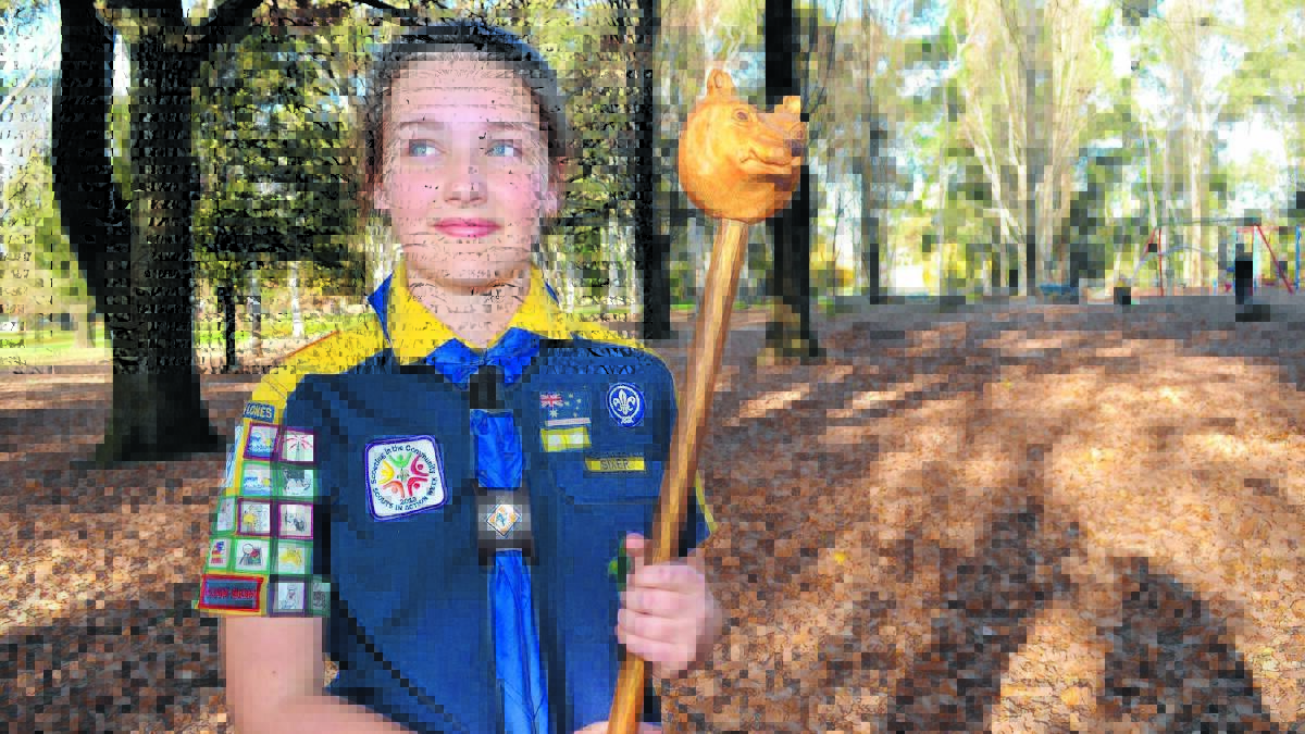 LEADER OF THE PACK: Ten-year-old Lone Scout Emily Spargo with the staff she made for a Cub Scout game. Emily has received her grey wolf badge, the highest honour in Cub Scouts. Photo: DANIELLE CETINSKI                                              0525emily1