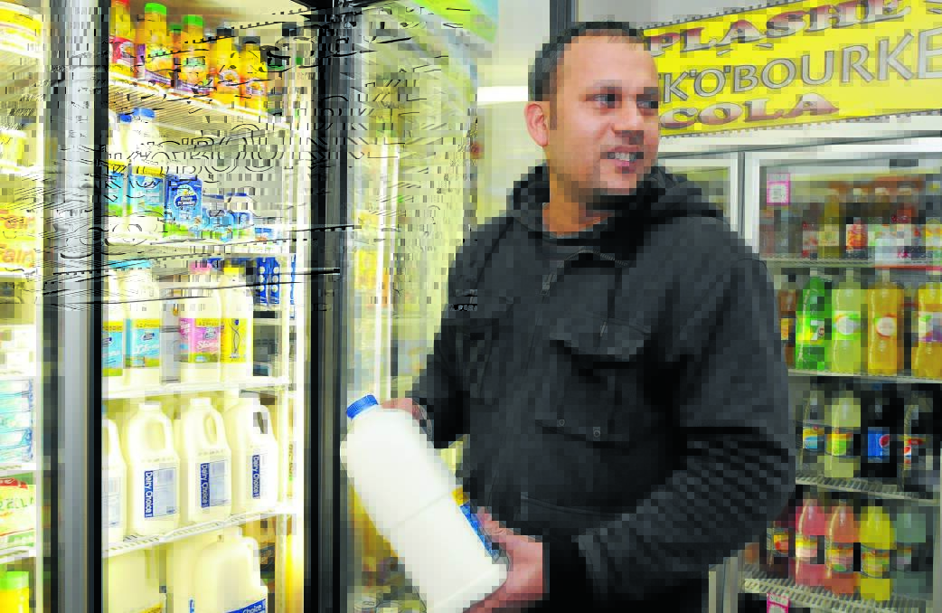 MILKY WAY: Owner of Gardiner Road Mini Market Lucky Singh says sales of Dairy Farmers and locally branded milk have increased over the past week. Photo: STEVE GOSCH.  
