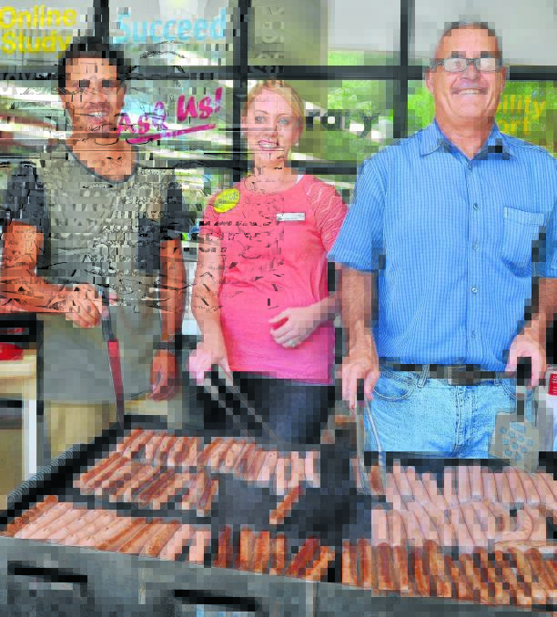 SNAG-FREE SAUSAGES: TAFE staff Sandon Gibbs-O'Neill, Rachael Buckerfield and Ian Long cook the barbecue to welcome students and help them settle in. Photo: STEVE GOSCH  