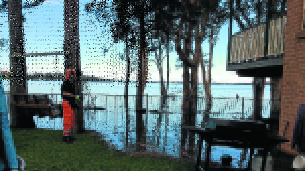 FLOOD RECOVERY: Orange City SES volunteer Grant Hill looks at the damage caused by high water levels in the Wyong region last week.
Photo supplied
