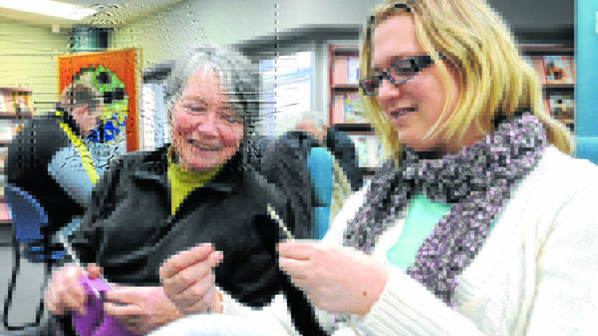 KNITTING FOR A CAUSE: Orange Purlers Judith Clarke and Katherine White attend the knit-in at Orange City Library every week.
Photo: STEVE GOSCH 0717sgwrap2

