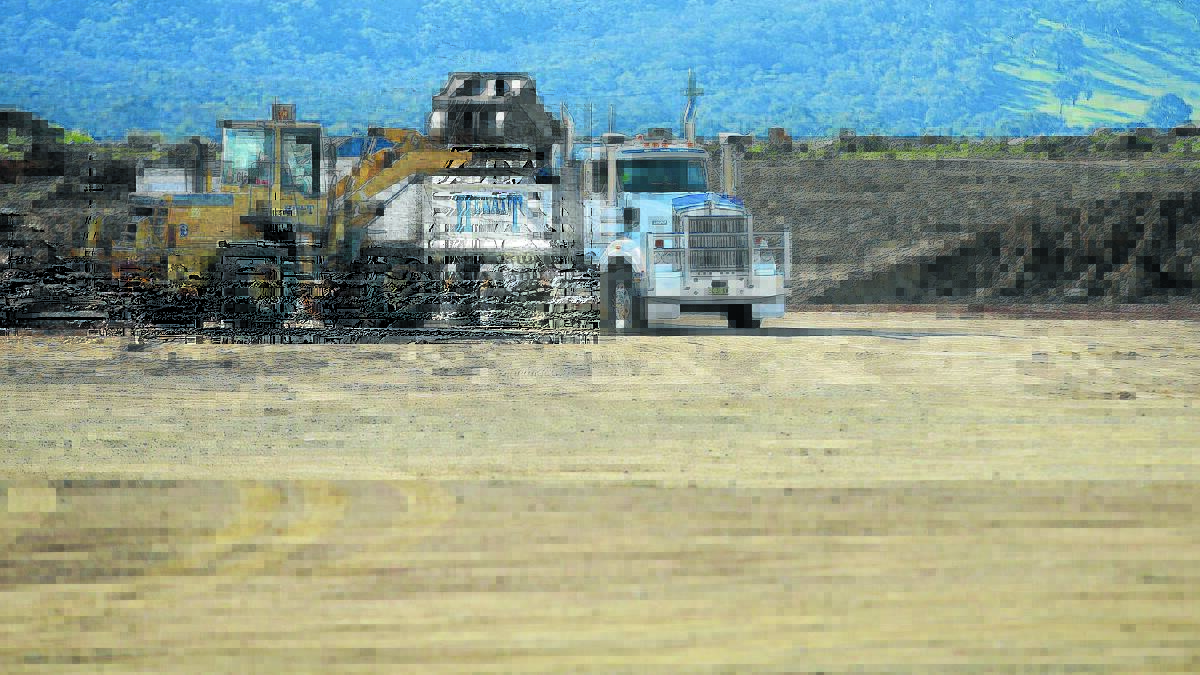ROAD TO RUIN: Hewatt Earthworks vehicles on the site of the now-halted Majura Parkway project. Hewatt had been building Orange Airport's new runway before it entered voluntary administration. 
Photo: JEFFREY CHAN