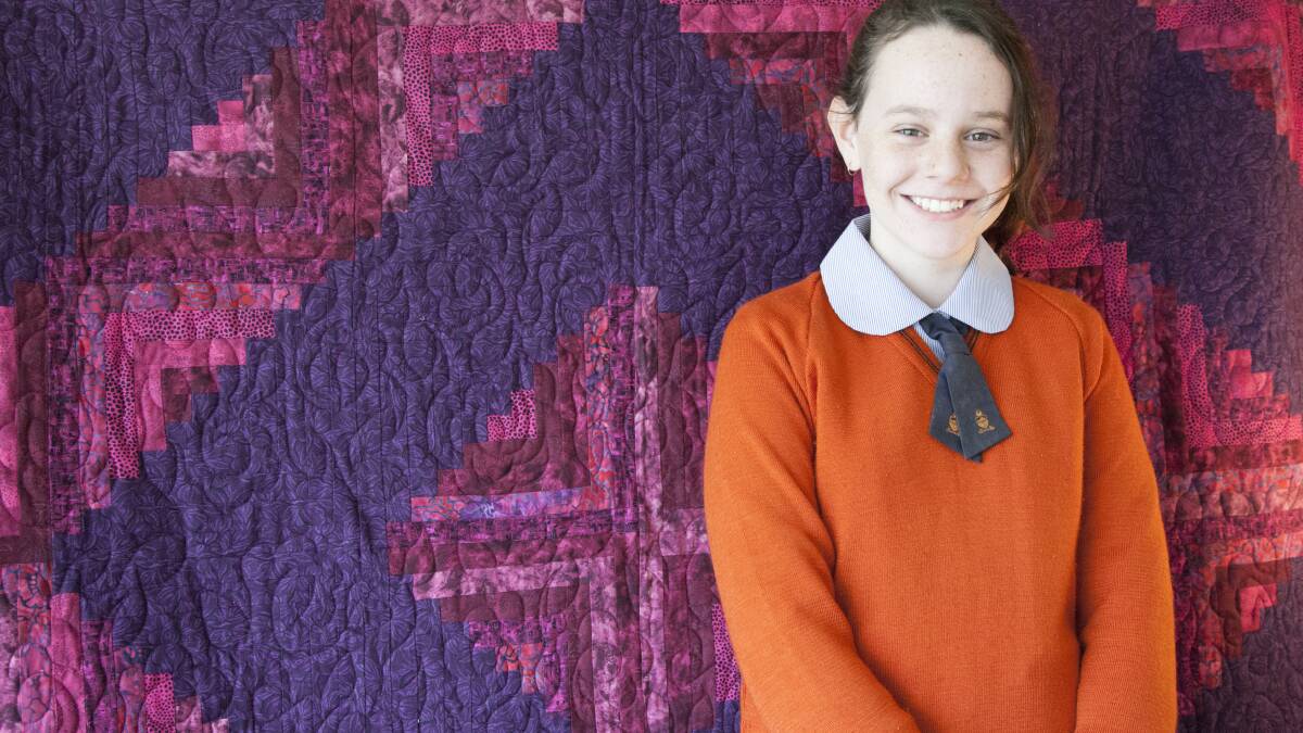 QUILTING STAR: Above, Isabella Noble with her first quilt that helped her win the Australasian Quilt Convention’s award for promising junior quilters. Photo: LEN ELLIOT 